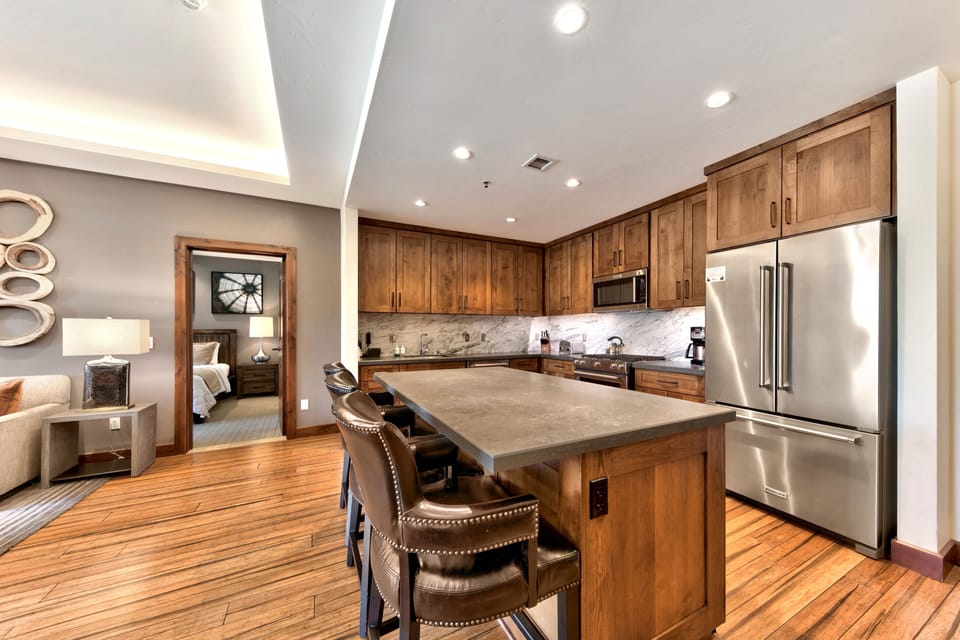Your spacious kitchen features warm wood cabinetry, granite countertops, and stainless steel appliances for all your culinary needs.
