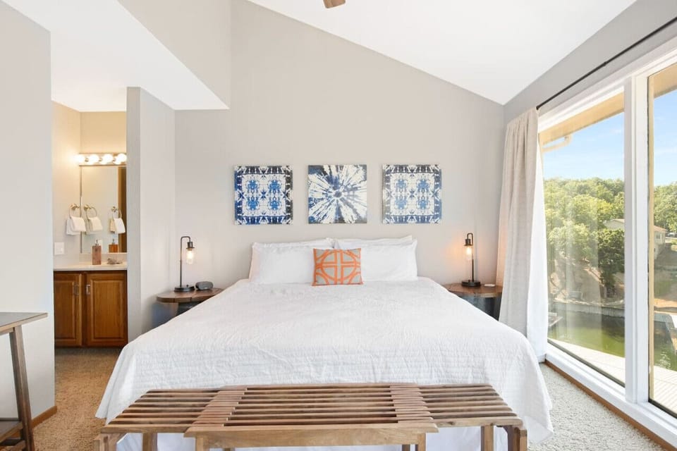 The primary bedroom offers a tranquil space with an attached bathroom and a beautiful view.