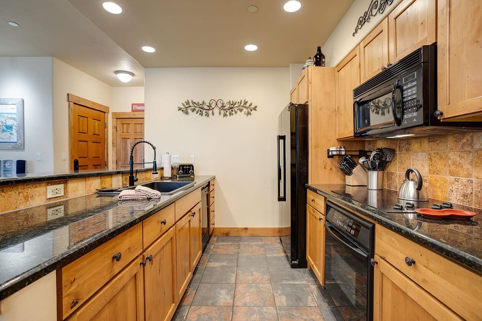 Your fully equipped kitchen features granite counters, modern appliances, and warm wood cabinets for memorable meal prep.