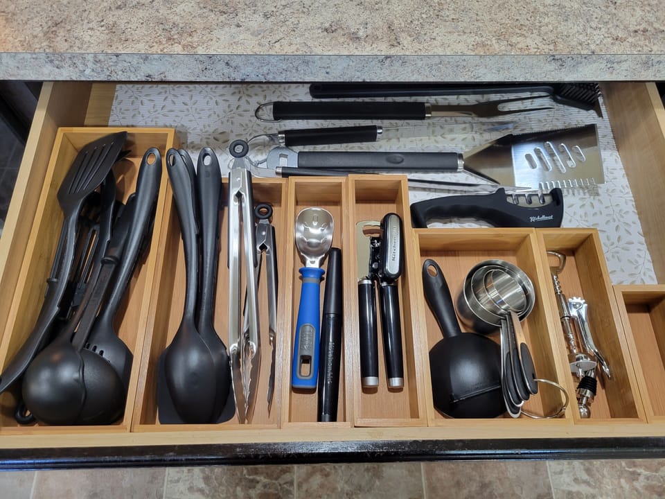 Fully stocked with grilling and cooking utensils.