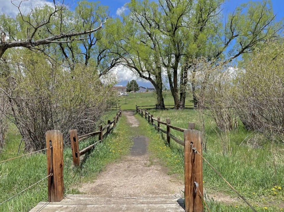 Backyard gate leads to a big park with lots of sport areas and nature