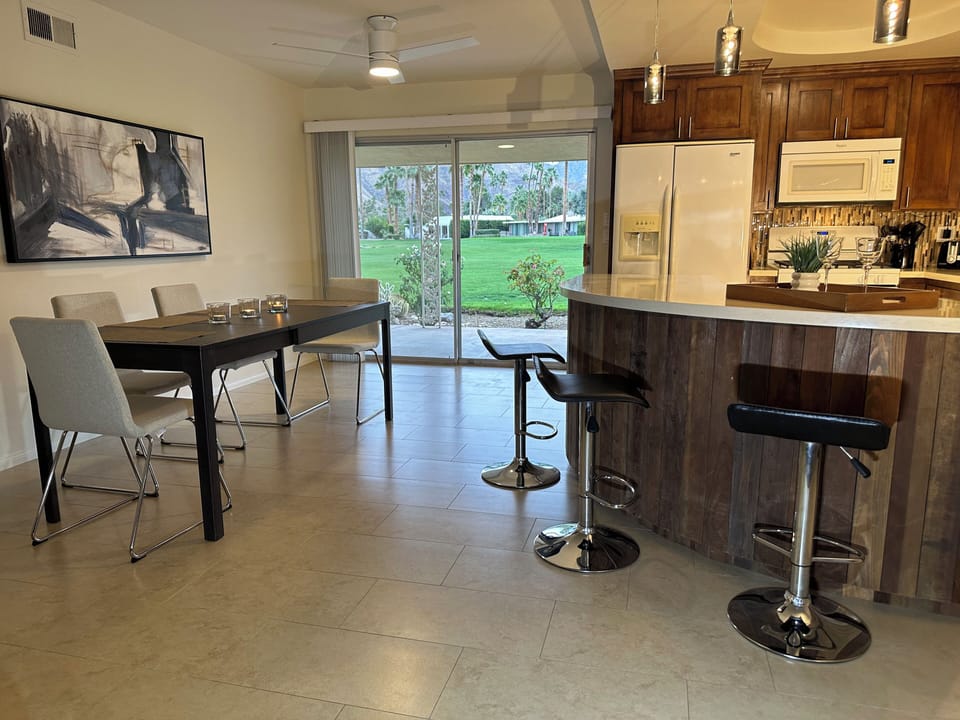 Another view of kitchen, bar, and dining area.