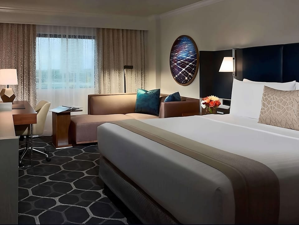 Stretch out on a plush king bed beside a cozy sofa.