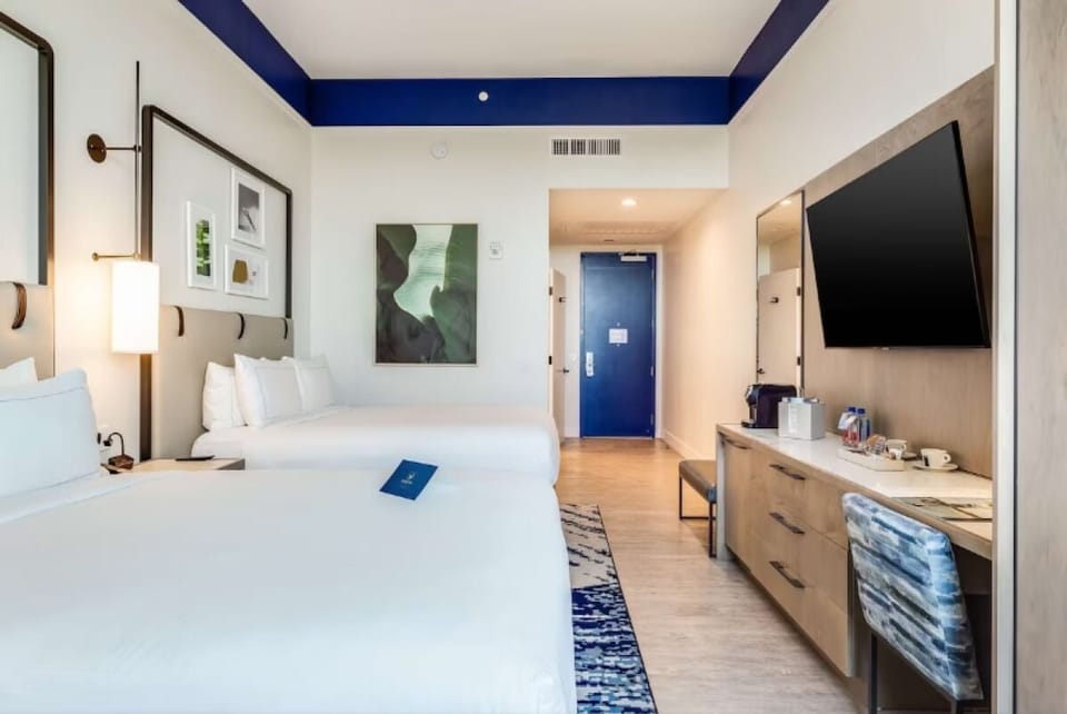Recharge and work easily with desk, TV, and airy layout.