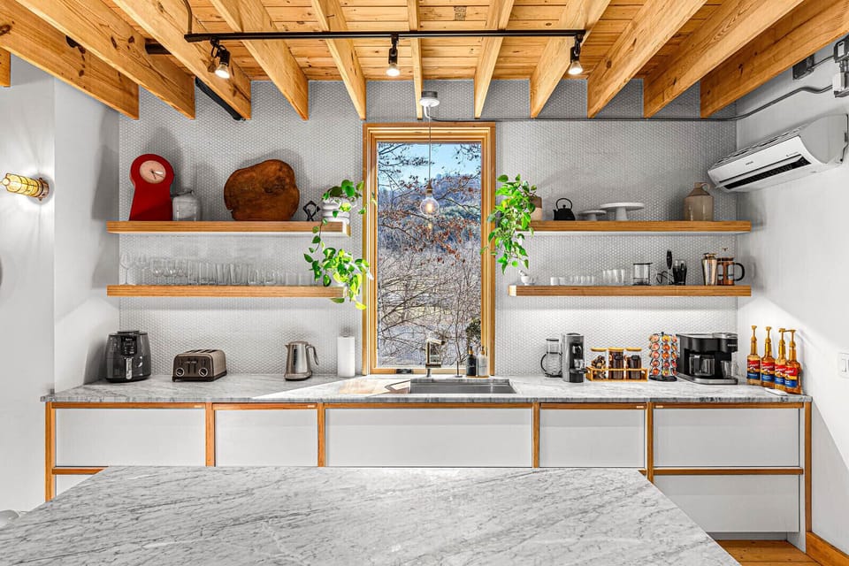 The modern kitchen is perfect for cooking up delicious meals or enjoying a casual breakfast. Enjoy the mountain views while you prepare your favorite dishes.
