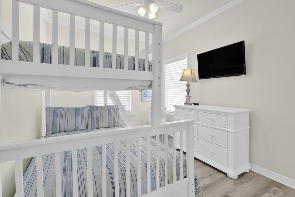 Bedroom 3 - Bedroom 3 features a twin over full bunk bed, a small dresser, and mounted television.
