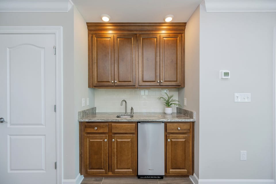 Enjoy a refreshing drink at the sleek wet bar, perfect for toasting to your relaxing getaway