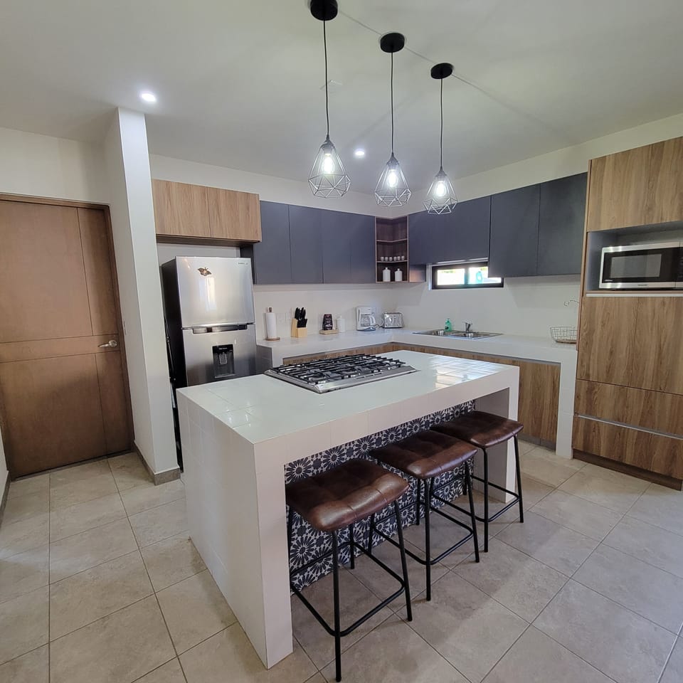 Gorgeous kitchen with gas stove, stainless steel refrigerator, and microwave