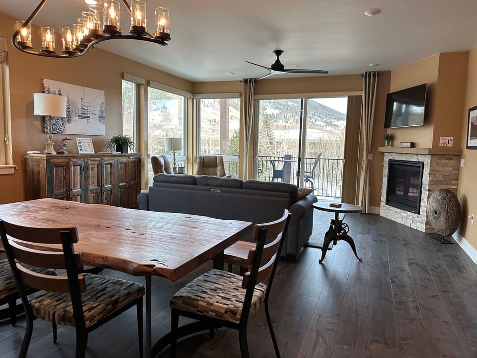 Bright cozy large living area. Floor to ceiling windows with mountain views.