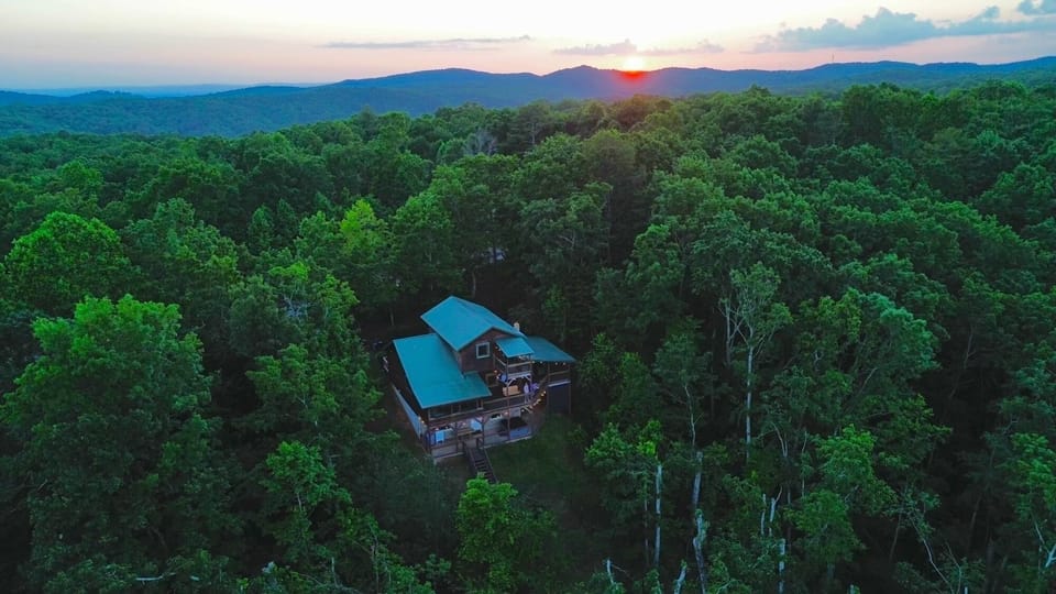 View of the back of the house with sunset in the background.