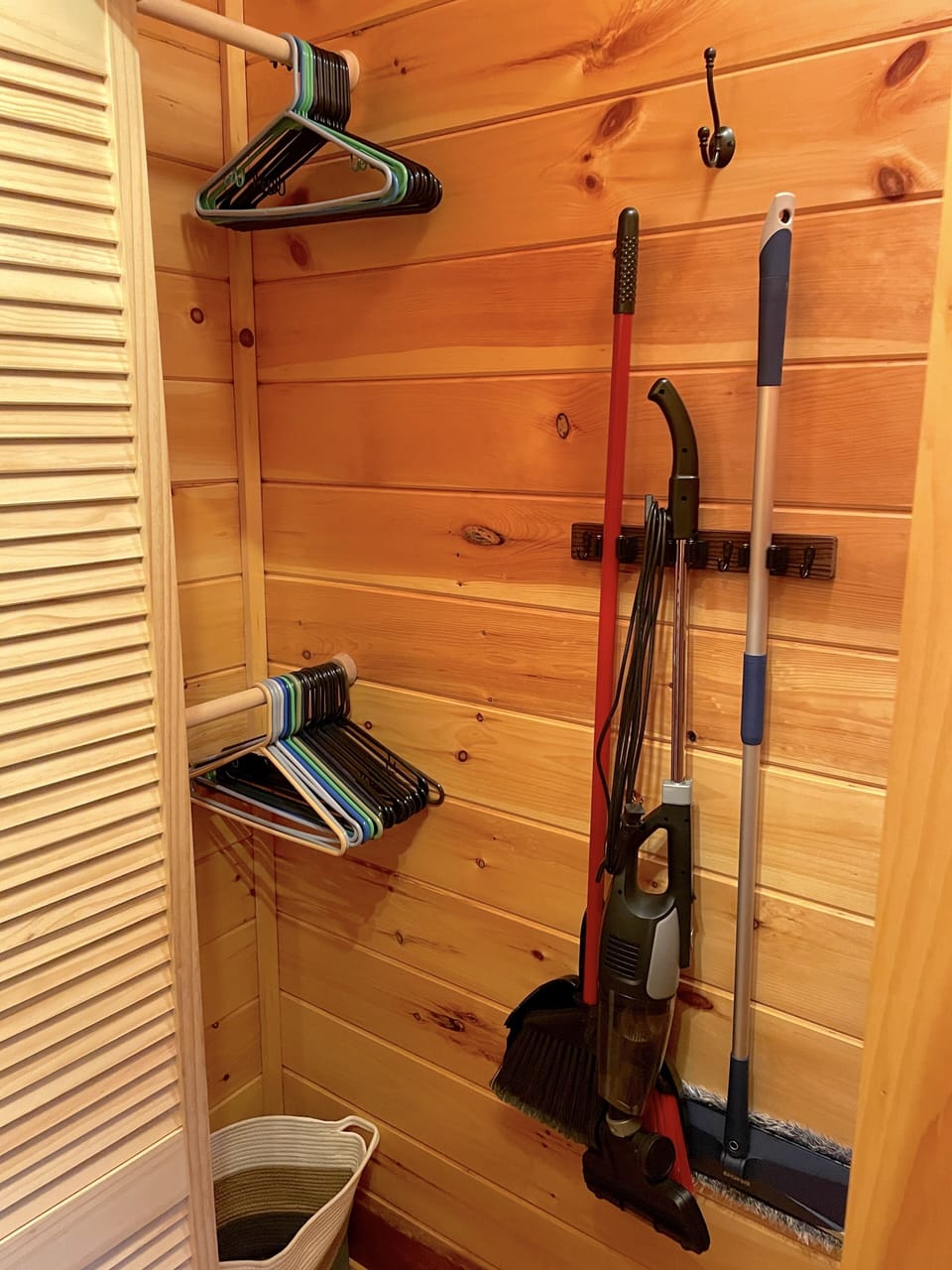 Second closet in main bedroom with cleaning supplies and more storage.