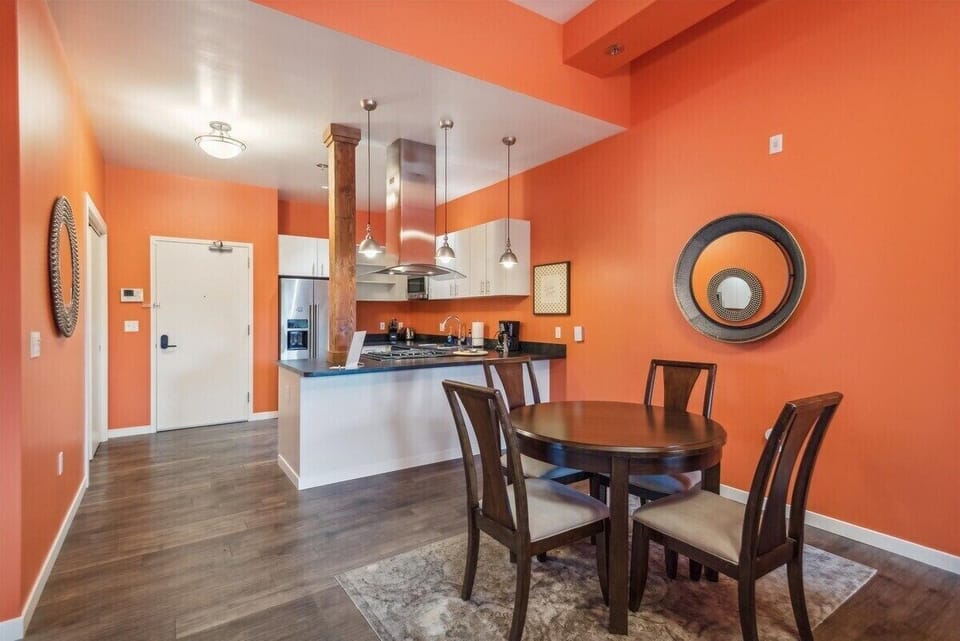 A bright, cheerful dining space with light-toned furnishings, playful accents, and a warm, inviting ambiance.