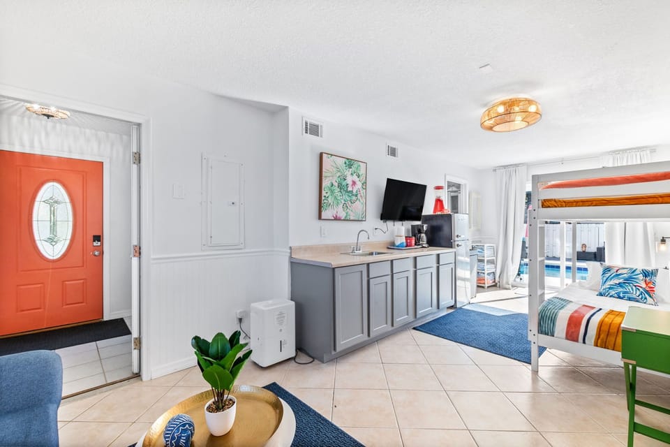 Enter on the main level to a full kitchenette w/a sink, coffee maker, slushie maker, fridge and 42" Roku tv