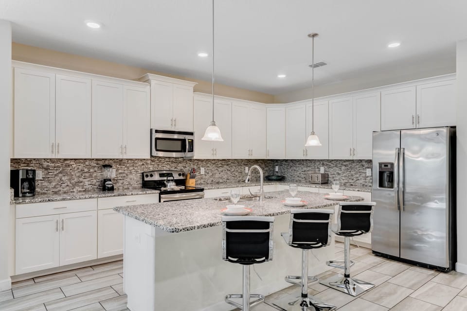 - Modern kitchen with stainless steel appliances included  
- Granite countertops and large island with seating area  
- Fully equipped for family meals during your vacation