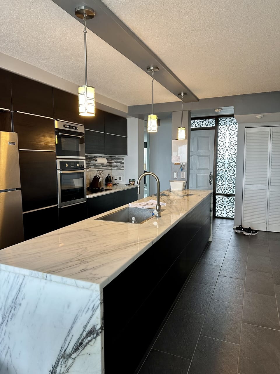 Gourmet kitchen/marble countertops, stainless appliances, wine fridge