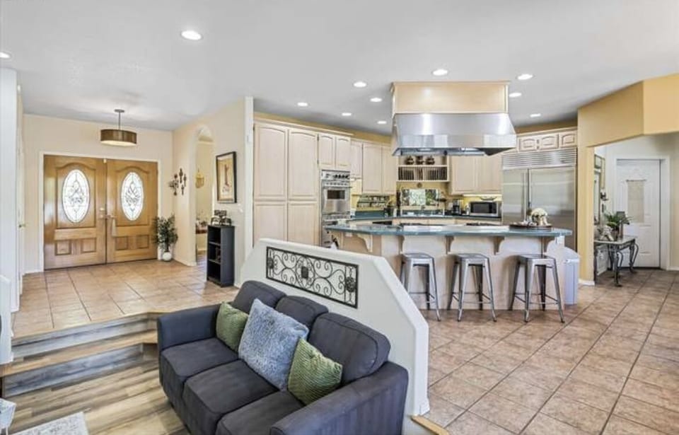 Open concept living room and gourmet kitchen area that look out to mountain view
