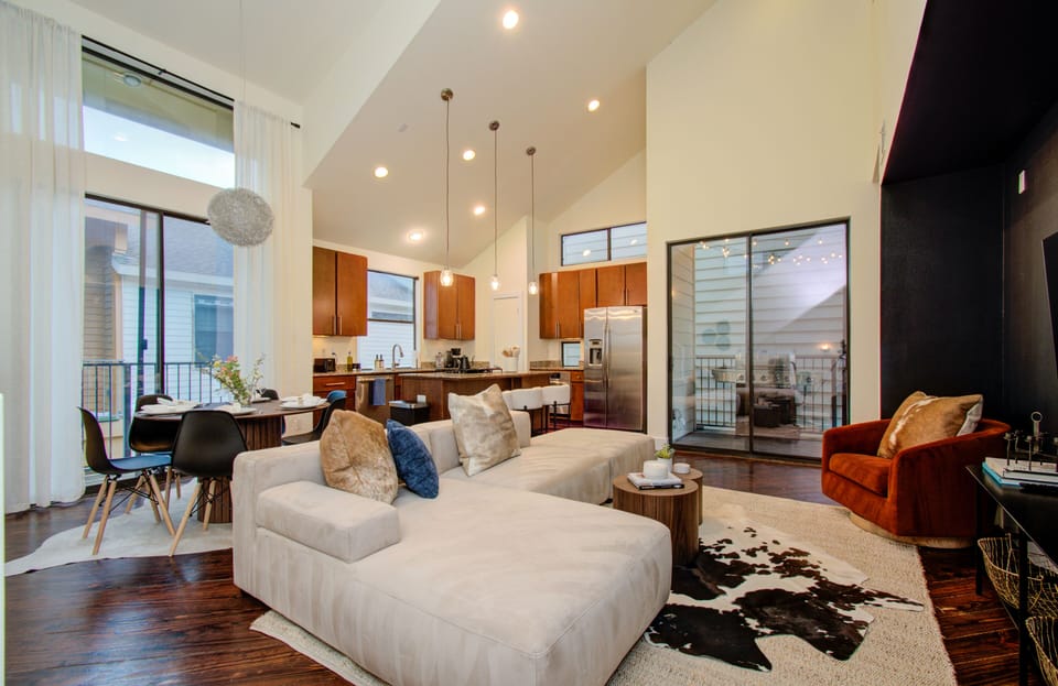 Open concept area featuring living room, kitchen, dining, and access to balcony
