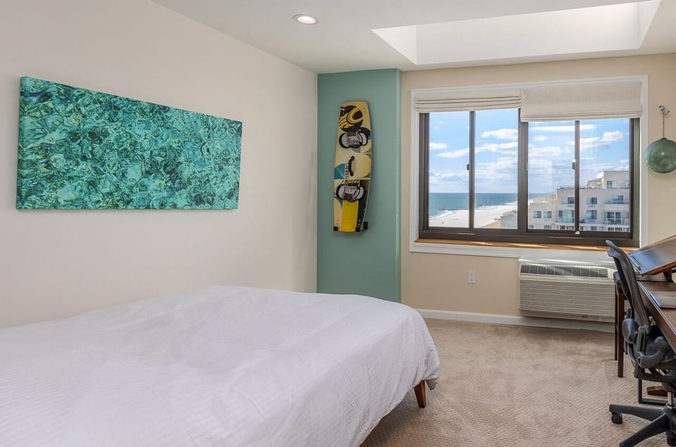 Guest bedroom with skylights, ocean views, walnut desk & Herman Miller chair.