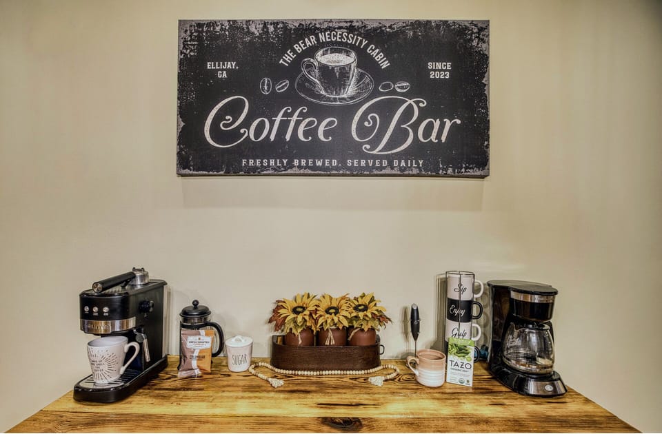 Wake up to your perfect brew! The dining area features a coffee bar with espresso and regular coffee machines, stocked with starter coffee, cream, and sugar, all set on a beautiful console cabinet. A cozy start to your mornings awaits!