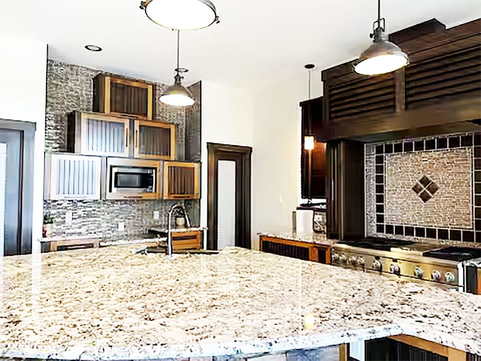 Kitchen's view showing beautiful architecture and an island.