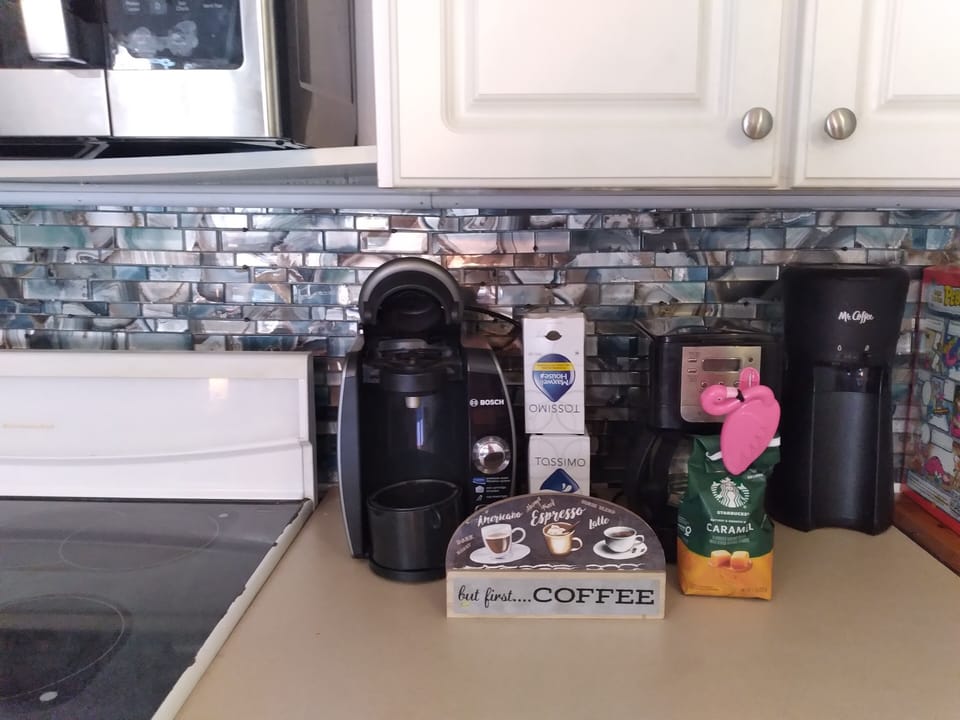 Fully stocked kitchen with coffee maker, blender, toaster. kettle and Krueg