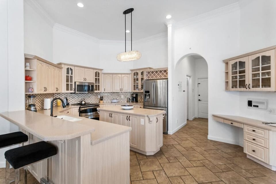 Fully stocked kitchen with center island, bar counter and work space