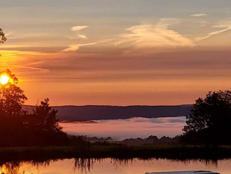 Sip coffee above the clouds.  View from the pond.