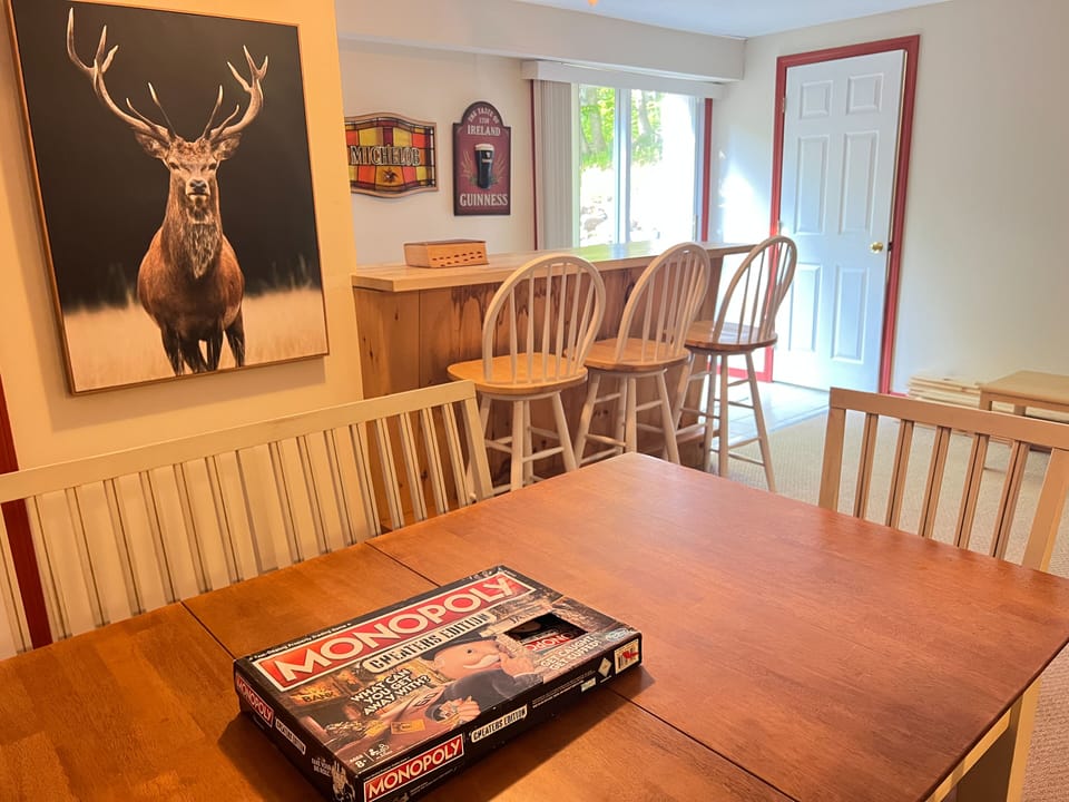 Downstairs family/entertainment space - extra table sits 6, couch, 85'TV & bar