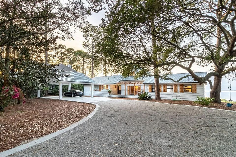 Front of house and carport located behind a private gate entrance