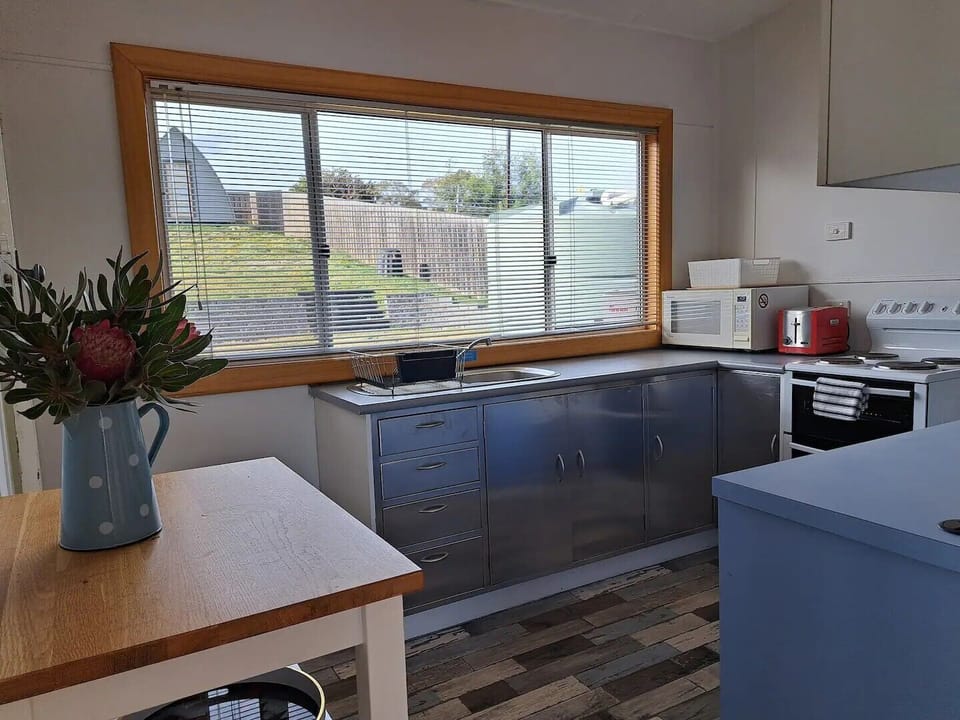 Sunny kitchen overlooking fully fenced backyard 