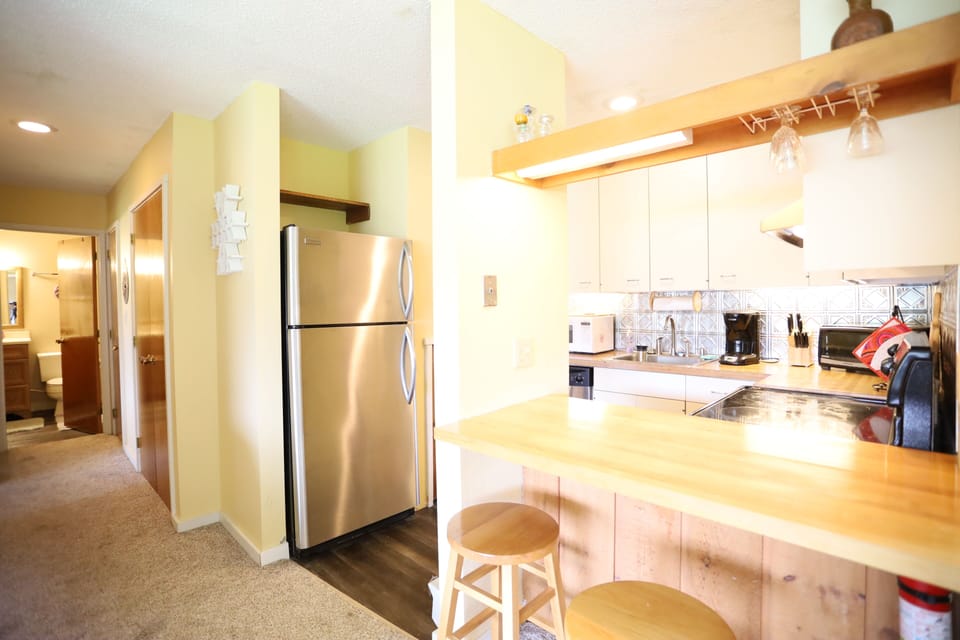 Full Kitchen with Serving Counter in Cozy Condo