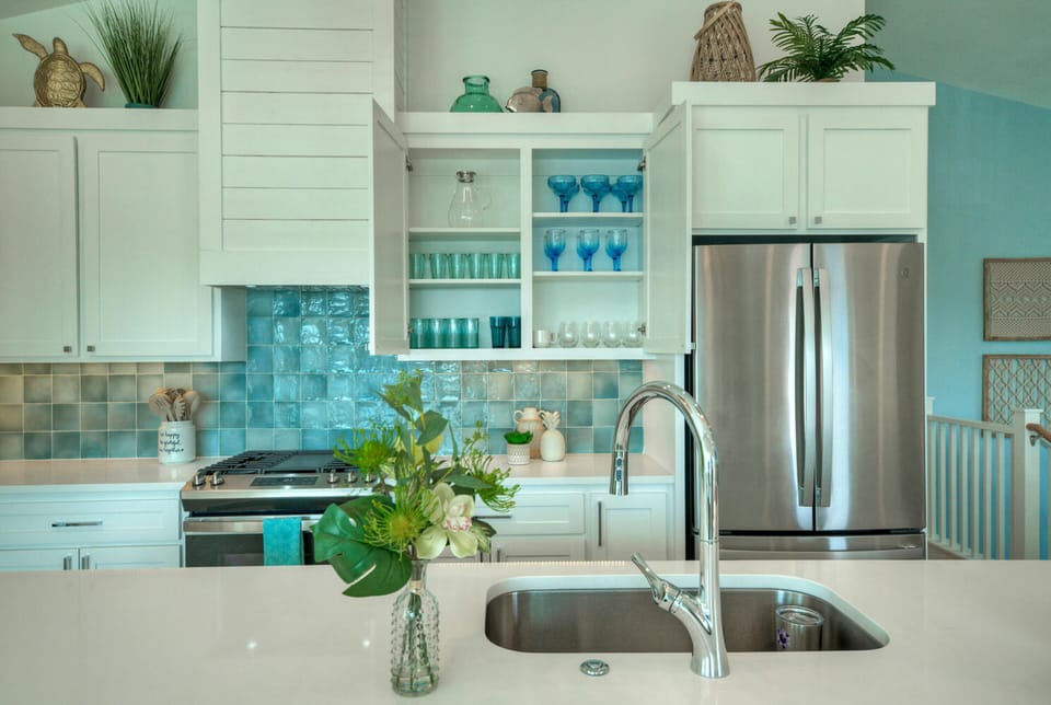 Fully equipped kitchen with beautiful glassware and dinnerware.