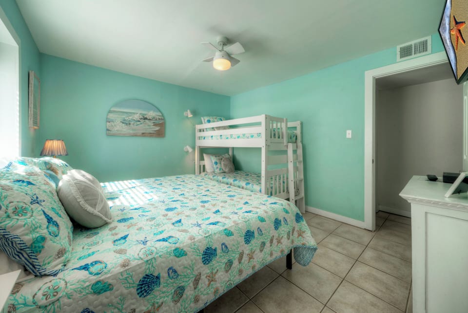 Bunk room featuring a twin over twin bunk bed and a king bed.