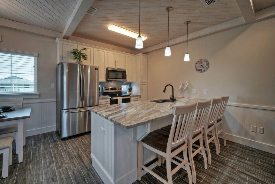 Kitchen with countertop and barstool seating.