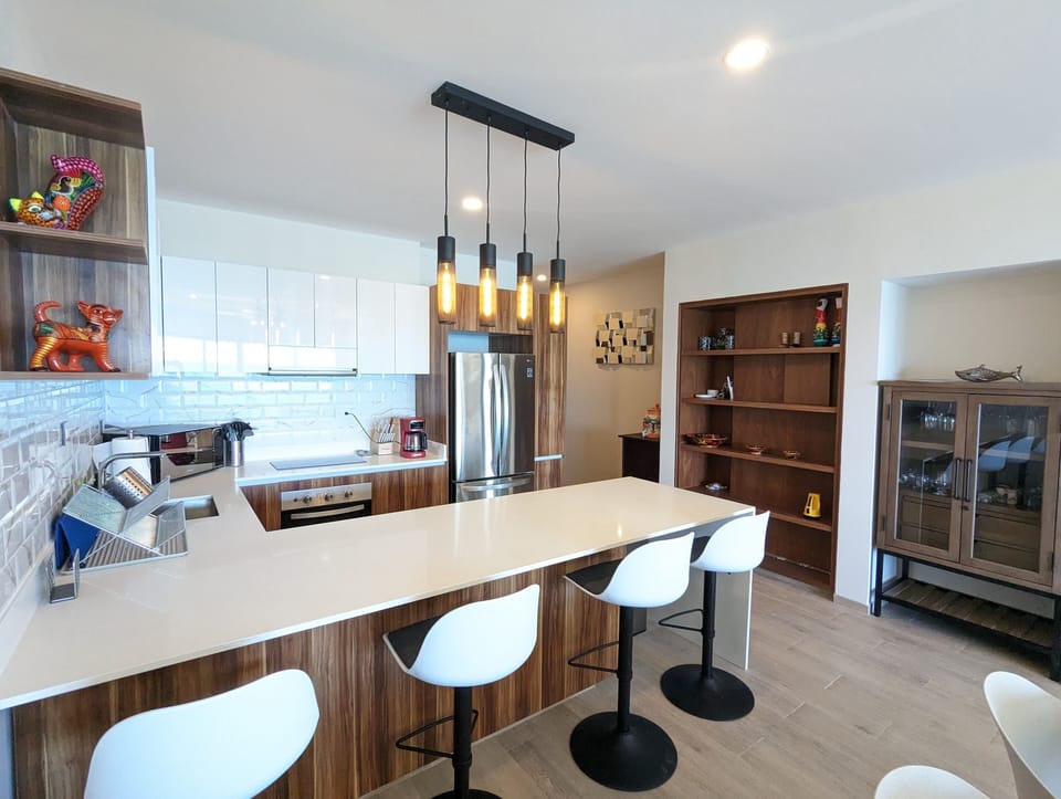 The bar cabinet has wine glasses, margarita glasses, martini glasses, and even beer mugs.