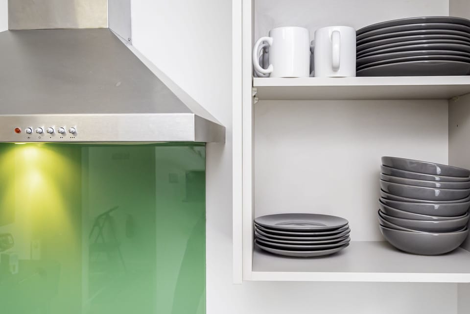 The kitchen is stocked with an assortment of glassware.