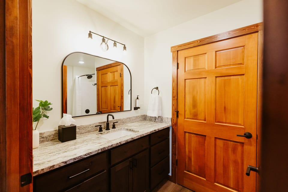 [Bathroom] There is plenty of counter space for getting ready. Shampoo, conditioner, body soap, and hand soap are provided.