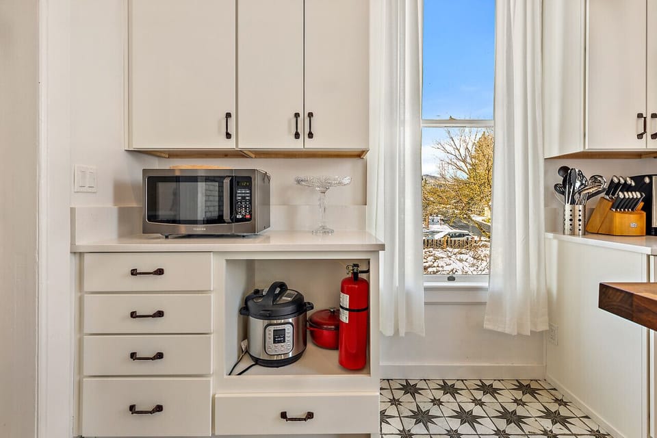 Kitchen with microwave, dutch oven, and instant pot