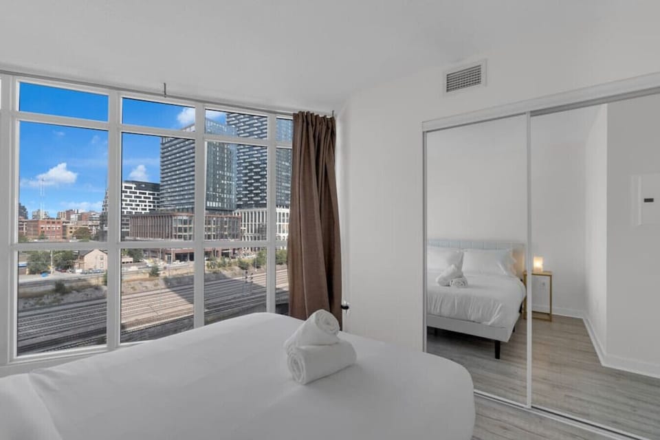 Spacious bedroom with queen size bed and a view and closet for storing your belongings.
