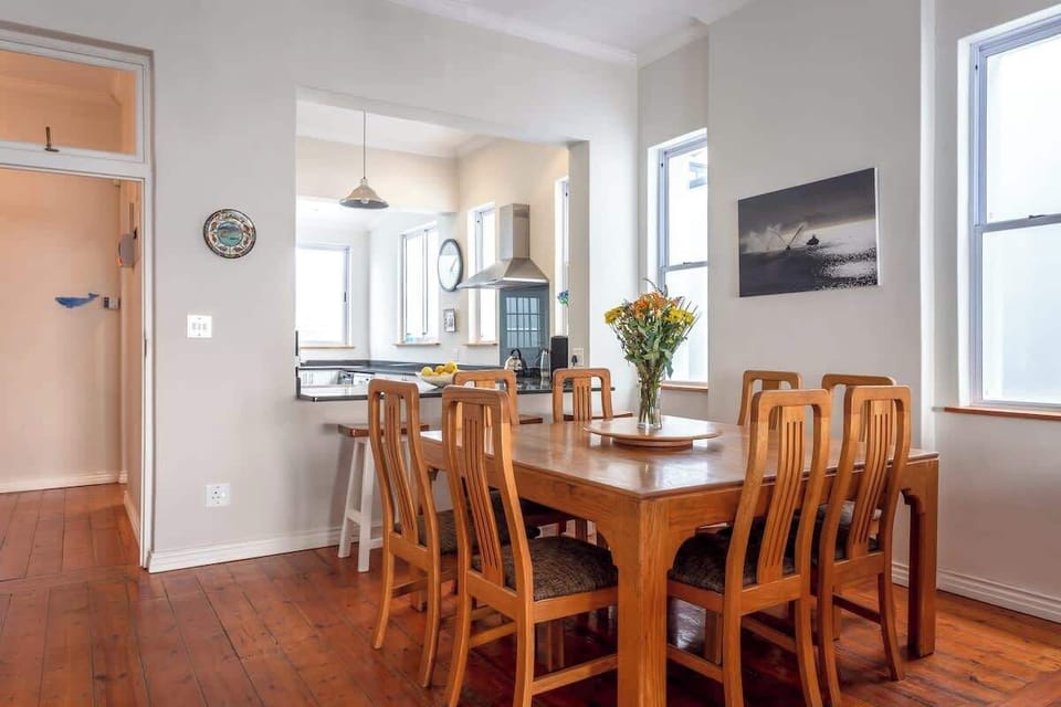 A large dining room table seating 8. Perfect for small dinner gatherings or perhaps a necessary space for those needing to get a little bit of work done. Complete with a Lazy Susan in the middle.