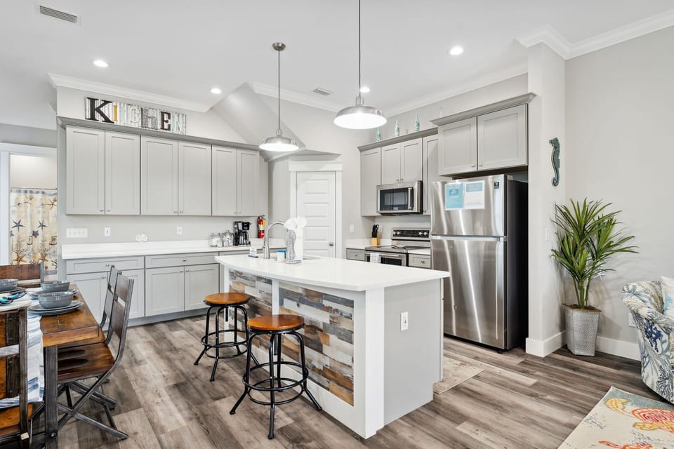 Large kitchen with island and eat in kitchen table.