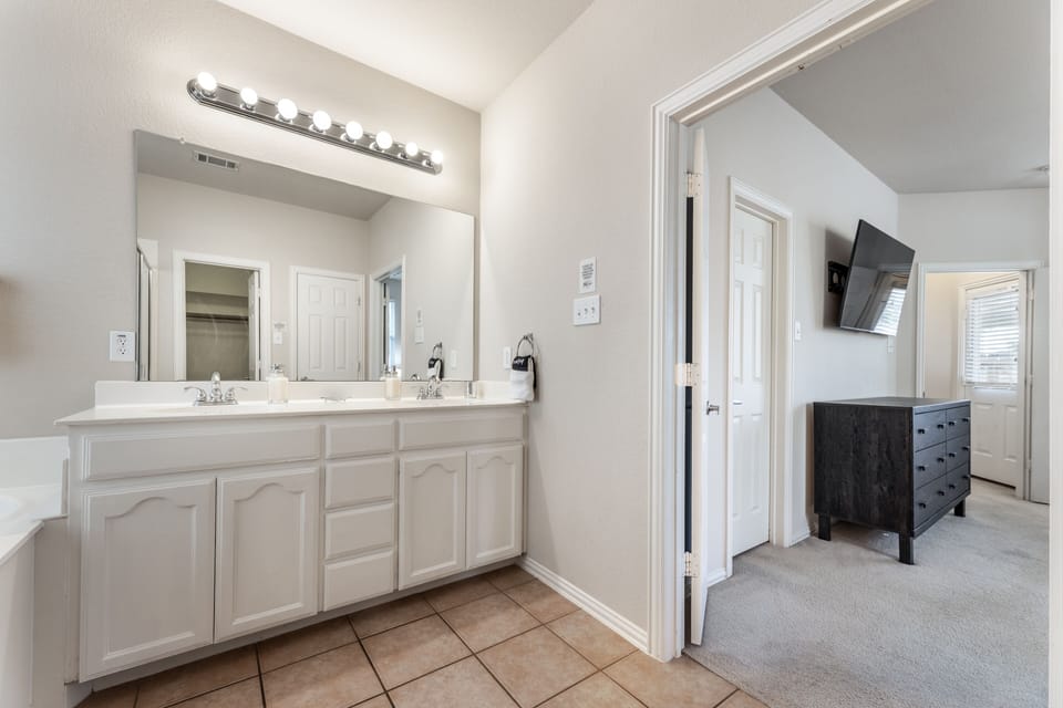 right and roomy ensuite with double vanities, full-size tub