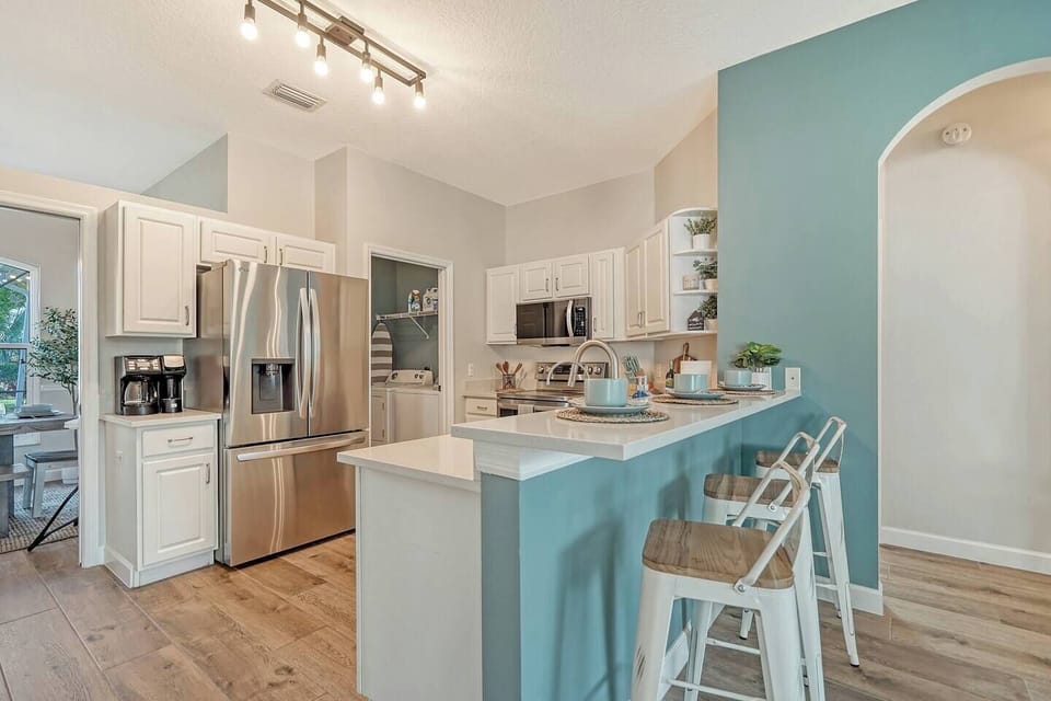 You will find the Kitchen stocked, stylish, and equipped with fun amenities like poolside dishes and glassware, a NEW Ninja DualBrew XL Grounds & Pods/Cold & Hot Coffee Maker, Crockpot,  built-in oven air-fryer and more!
