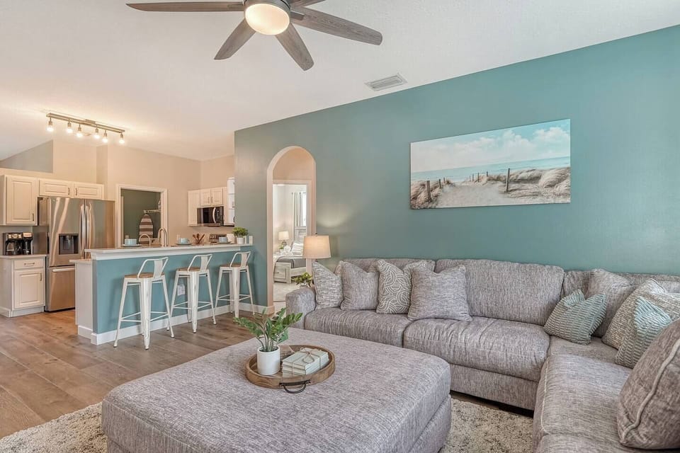 Welcome to our spacious Family Room, bathed in natural light. Our open-concept kitchen with a breakfast bar flows seamlessly into our cozy Family Room, creating the perfect space for family gathers.