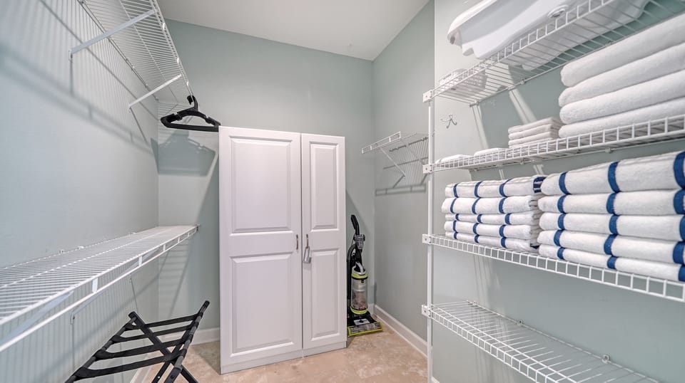 Walk into your primary bedroom closet offering ample space for your belongings.