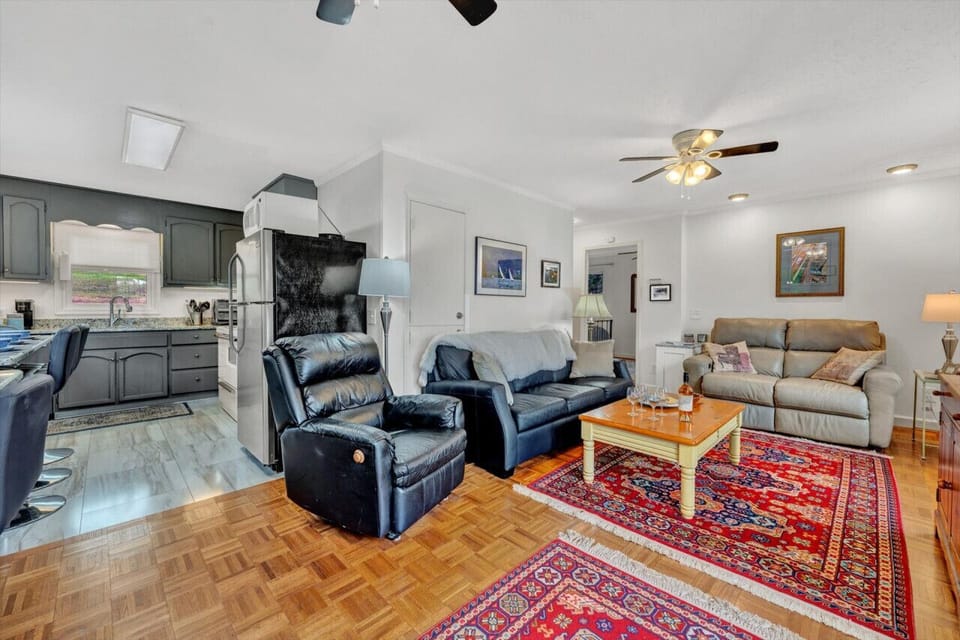The living room`s large windows let in natural light, creating a warm and inviting space.