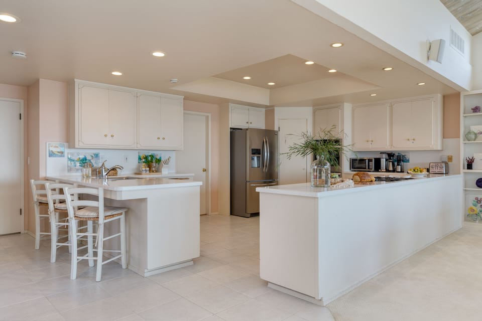 Fully-equipped kitchen with barstool seating.