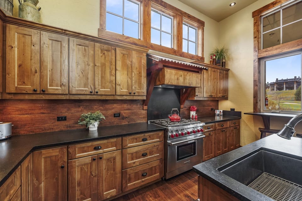 Indulge your culinary passions in this high-end mountain home kitchen equipped with premium Wolf appliances