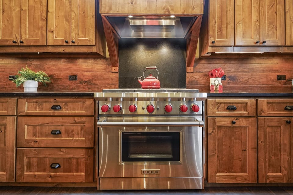 Indulge your culinary passions in this high-end mountain home kitchen equipped with premium Wolf appliances