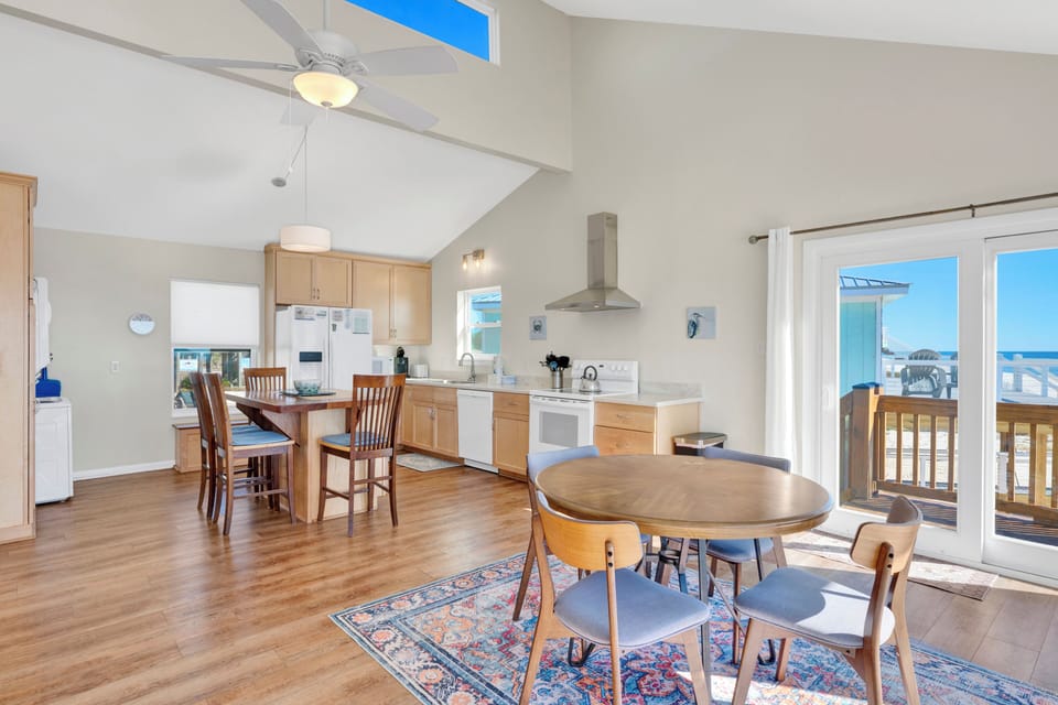 Seating for four at the dining table with additional seating at the kitchen island